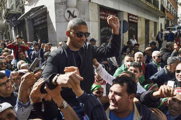 A picture taken on March 6, 2020 shows Algerian protesters carrying journalist Khaled Drareni on their shoulders. (File photo: AFP)