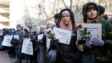 FILE PHOTO: People hold posters with names of victims of the Ukraine International Airlines flight 752 plane disaster during a commemoration ceremony in front of the Iranian embassy in Kiev, Ukraine February 17, 2020. REUTERS/Valentyn Ogirenko/File Photo
