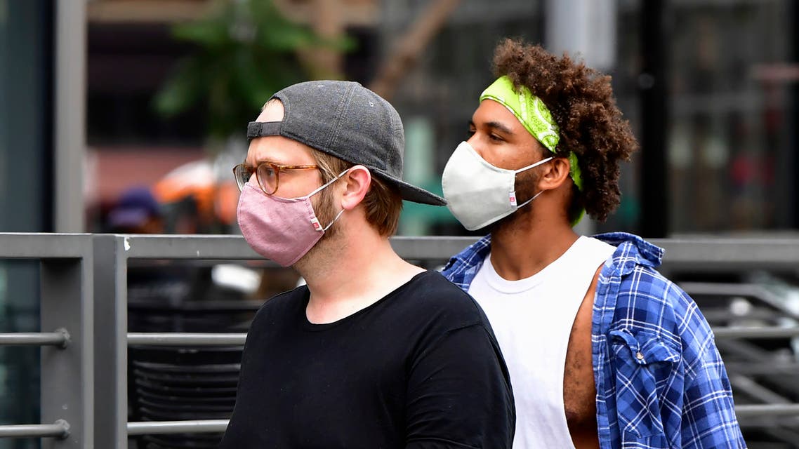 Young men wearing facemasks due to the coronavirus pandemic are seen in Los Angeles on June 29, 2020 where the largest single-day number of new COVID-19 cases in the county since the pandemic began was confirmed, with a spike among the younger population. The coronavirus pandemic is not even close to being over, the WHO warned today, as the global death toll passed half a million and cases surge in Latin America and the United States.