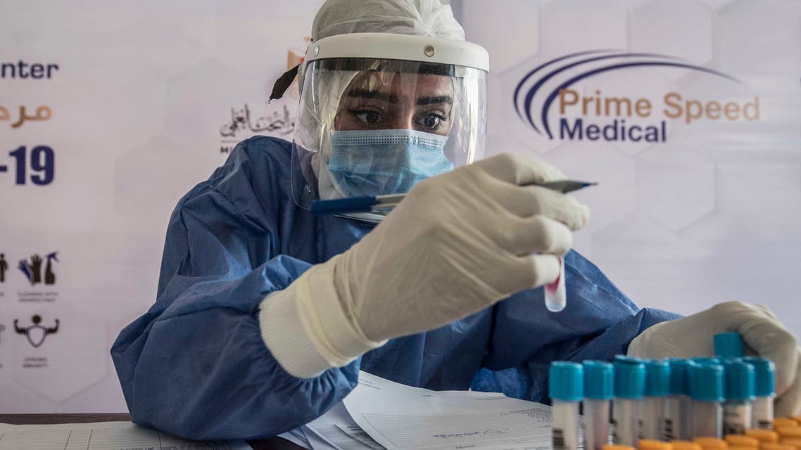 An Egyptian health worker checks samples at a drive-through coronavirus-testing center at the Ain Shams University in Cairo on June 29, 2020. Egypt has so far registered 65,188 COVID-19 cases including 2,789 fatalities.