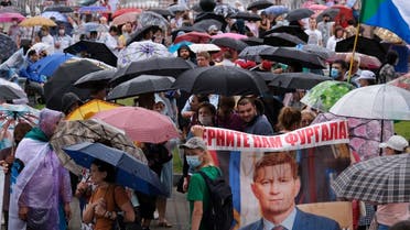 People carry a banner reading Return Furgal for us, during an unauthorised rally in support of Sergei Furgal in the Russian far eastern city of Khabarovsk on August 1, 2020. (AFP)