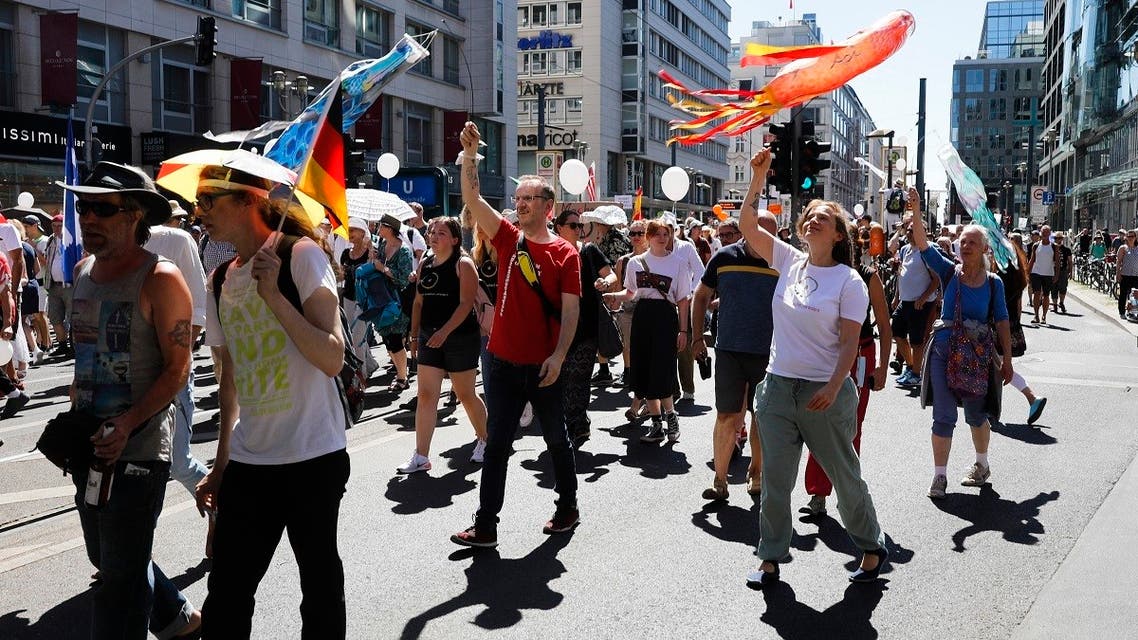People mostly without face masks attend a demonstration with the slogan ‚The end of the pandemic - freedom day' - against coronavirus restrictions in Berlin, Germany, on August 1, 2020. (AP)
