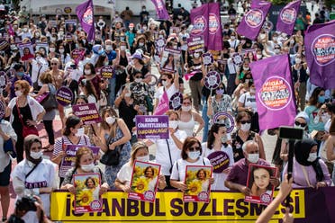 Demonstrators hold placards and portraits of women, during a protest for better implementation of the Istanbul Convention in Istanbul, Turkey. (AFP)