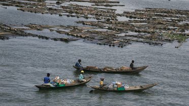 Women on canoes sells snacks and bottled water on the Lagoon, in Lagos Nigeria, Wednesday May 20, 2020. (AP)