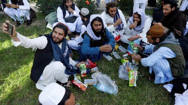 FILE PHOTO: A newly freed Taliban prisoner takes a selfie as other have juice and biscuits at Pul-i-Charkhi prison, in Kabul, Afghanistan May 26, 2020. REUTERS/Mohammad Ismail/File Photo