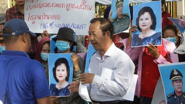 Rong Chhun, center, president of the Cambodian Confederation of Unions talks with a security, left, during a protest near the prime minister's residence in Phnom Penh, Cambodia, on July 29, 2020. (AP)