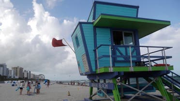 A red flag flies from a lifeguard station indicating high surf, Friday, July 31, 2020, in Miami Beach, Fla. Forecasters declared a hurricane warning for parts of the Florida coast Friday as Hurricane Isaias drenched the Bahamas on track for the U.S. East Coast. (AP