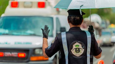 A Saudi security officer motions to an ambulance at a checkpoint in the Mecca region ahead of the annual hajj pilgrimage. (AP)