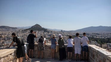 Tourists explore at Acropolis Hill, in Athens, Friday, July 31, 2020. Greece cautiously reopened its tourism industry, despite tough new coronavirus restrictions that came into force this week. Most of the new restrictions are unrelated to tourism. (AP Photo/Petros Giannakouris)