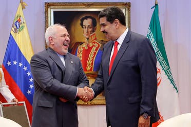 Venezuela's President Nicolas Maduro and Iran's Foreign Minister Mohammad Javad Zarif shake hands during their meeting in Caracas, Venezuela July 20, 2019. (Reuters)