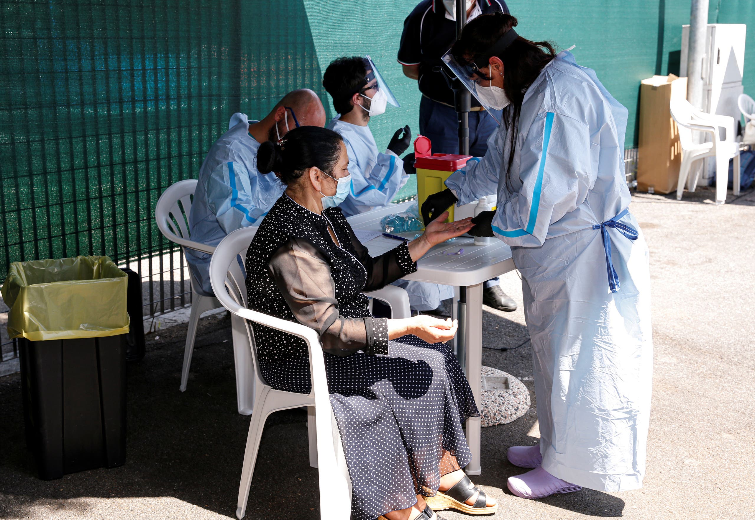 People arriving by coach from Romania take voluntary serological coronavirus disease (COVID-19) tests as part of increased security measures for 'risk' countries, in Rome, Italy. (File photo: Reuters)