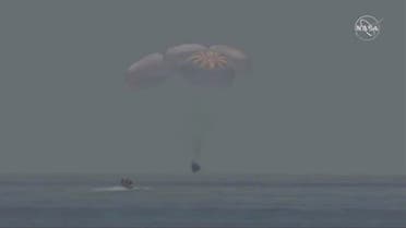 A capsule with NASA astronauts Robert Behnken and Douglas Hurley splashes down in the Gulf of Mexico, August 2, 2020, in this screen grab taken from a video. (NASA/handout via Reuters)