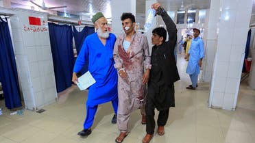 Men help an injured person in a hospital after blasts, in Jalalabad, Afghanistan August 2, 2020. (Reuters)