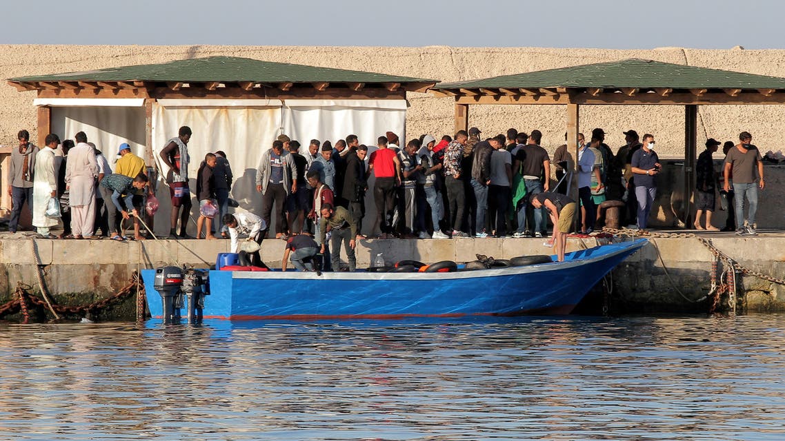 Migrants stand on a dock as they disembark a boat on the Sicilian Island of Lampedusa, Italy July 24, 2020. REUTERS/Mauro Buccarello TPX IMAGES OF THE DAY