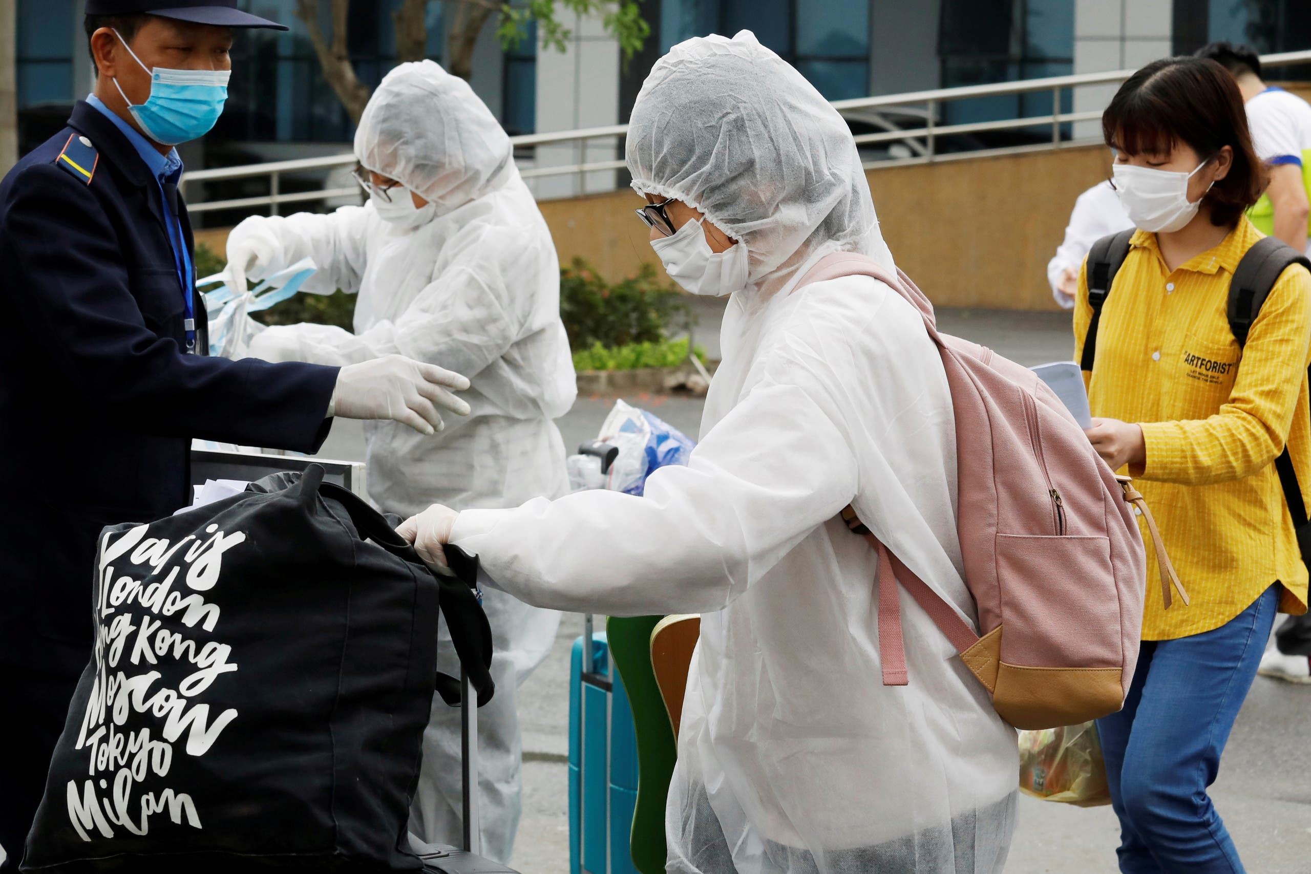 People previously suspected of being infected with the coronavirus wear protective face masks as they leave a hospital after being quarantined for 14 days in Hanoi, Vietnam April 2, 2020. (Reuters)