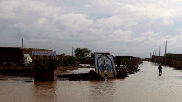 A man walks past the remains of a house destroyed by the floods caused by heavy rains in Khartoum August 6, 2013.  (Reuters)