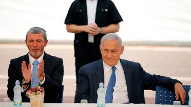 Israeli Minister Rafi Peretz sits next to Israeli Prime Minister Benjamin Netanyahu in the settlement of Elkana on Sept. 1, 2019. (File photo: AP)