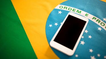 Brazilian flag background with smartphone stock photo