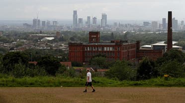 The skyline of Manchester is seen as a man exercises, amid the spread of the coronavirus disease (COVID-19), in Oldham, Britain, August 1, 2020. (Reuters)