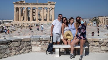 A French family takes a selfie in front of the ancient Parthenon temple in Athens on July 31, 2020. (AP)