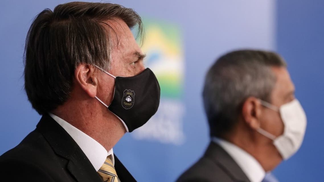 Handout picture released by Brazilian Presidency press office of President Jair Bolsonaro (L) and Chief of Staff Walter Souza Braga Netto at Planalto Palace in Brasilia, Brazil, on May 15, 2020. (AFP)