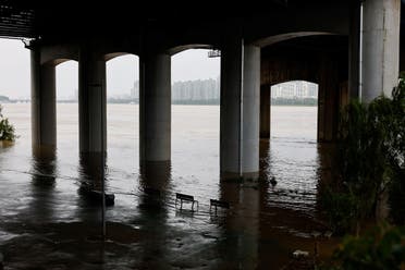 Partially submerged benches are seen by a flooded at a Han River Park in Seoul, South Korea, August 4, 2020. (Reuters)