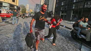 Wounded people walk near the site of an explosion at the port in the Lebanese capital Beirut on August 4, 2020. (AFP)