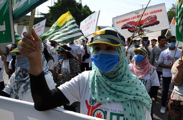 000_1WB03DActivists of Pakistan Youth Forum Kashmir hold placards and wave Azad Kashmir flags during a rally to show their solidarity with people of Indian-administered Kashmir, in Lahore, on August 5, 2020. (AFP)