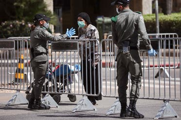 In this April 3, 2020 file photo, Israeli police officers block a main road following the spread of the coronavirus, in Bnei Brak, a suburb of Tel Aviv, Israel. (AP)