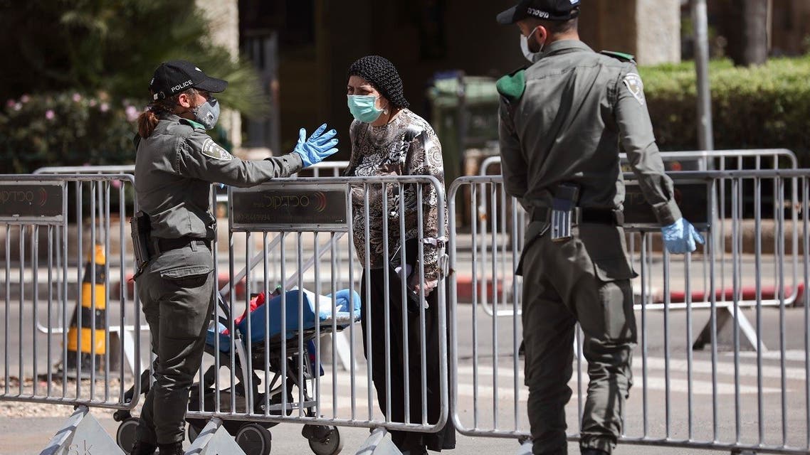 In this April 3, 2020 file photo, Israeli police officers block a main road following the spread of the coronavirus, in Bnei Brak, a suburb of Tel Aviv, Israel. (AP)