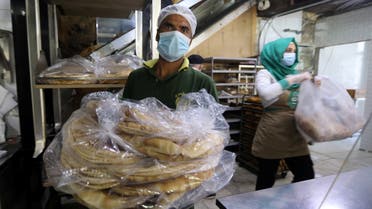 Workers carry bread inside a bakery in Beirut, following Tuesday's blast in city's port area, Lebanon August 5, 2020. REUTERS/Mohamed Azakir