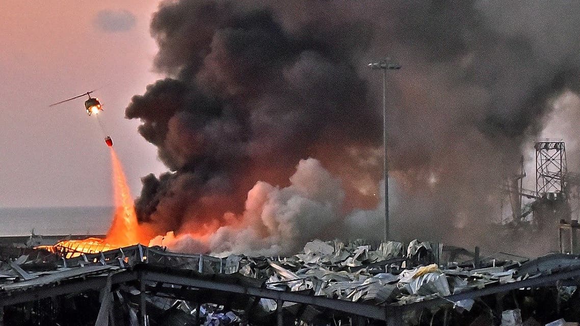 A helicopter puts out a fire at the scene of an explosion at the port of Lebanon's capital Beirut. (AFP)