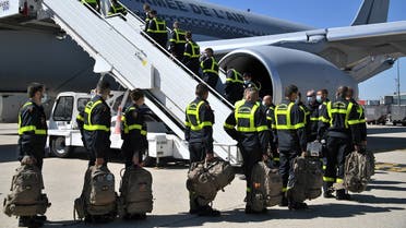 French Securite Civile (Civil Security) personnel board a Airbus A330, at Roissy airport near Paris, on August 5, 2020, as France is sending search and rescue experts aboard three military planes loaded with a mobile clinic and tonnes of medical equipment to Beirut. (AFP)