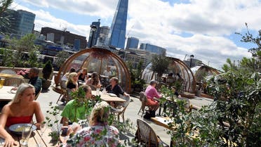 People eat outside and inside private dining pods, on the terrace of a restaurant, as the outbreak of the coronavirus disease (COVID-19) continues, in London, Britain, August 6, 2020. REUTERS