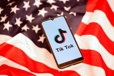 TikTok's logo is displayed on the smartphone while standing on the US flag in this illustration picture. (Reuters)