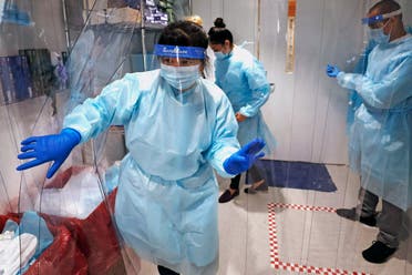 Lena Landaverde, assistant director of the Precision Diagnostics Center, heads to the new COVID-19, on-campus testing labs after donning personal protective equipment, Thursday, July 23, 2020, at Boston University in Boston. (AP)