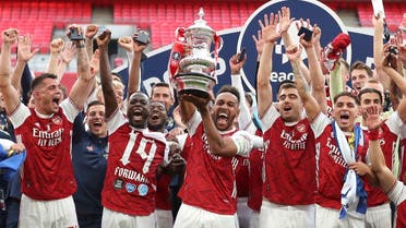 Arsenal’s players celebrate with the trophy after the FA Cup final soccer match between Arsenal and Chelsea at Wembley stadium in London, England, on August 1, 2020. (AP) 