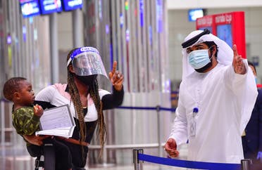 A tourist receives instruction at Dubai airport in the United Arab Emirates on July 8, 2020. (AFP)