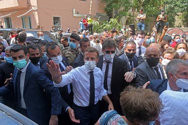 French President Emmanuel Macron greets people as he visits the Gemmayzeh neighborhood in Beirut. (AFP) 