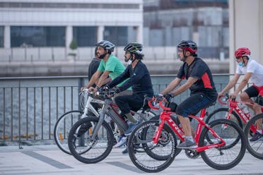Sheikh Mohammed with his associated cycling in Dubai city. (Dubai Media City)