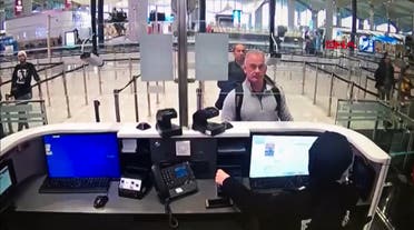 This handout video grab image released by The Istanbul Police Department to DHA News Agency on January 17, 2020, shows Michael Taylor (2R) and George Antoine Zayek (C) at passport control in Istanbul Airport, two men accused of helping fugitive businessman Ghosn escape. (File photo: AFP)