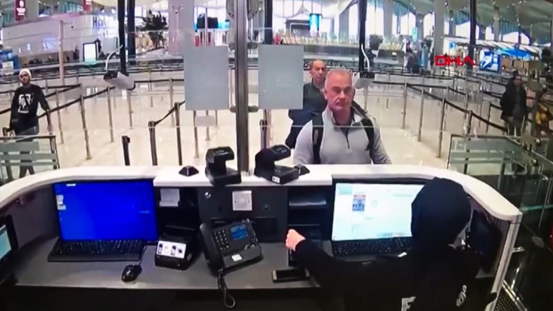 This handout video grab image released by The Istanbul Police Department to DHA News Agency on January 17, 2020, shows Michael Taylor (2R) and George Antoine Zayek (C) at passport control in Istanbul Airport, two men accused of helping fugitive businessman Ghosn escape. (AFP)
