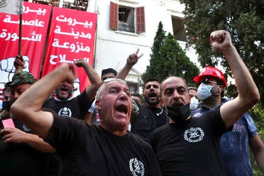 Retired army officers chant slogans inside the Lebanese foreign ministry in Beirut, Lebanon, Saturday, Aug. 8, 2020. (AP)