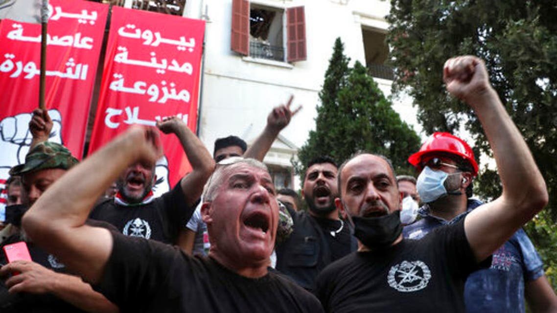 Retired army officers chant slogans inside the Lebanese foreign ministry in Beirut, Lebanon, Saturday, Aug. 8, 2020. (AP)