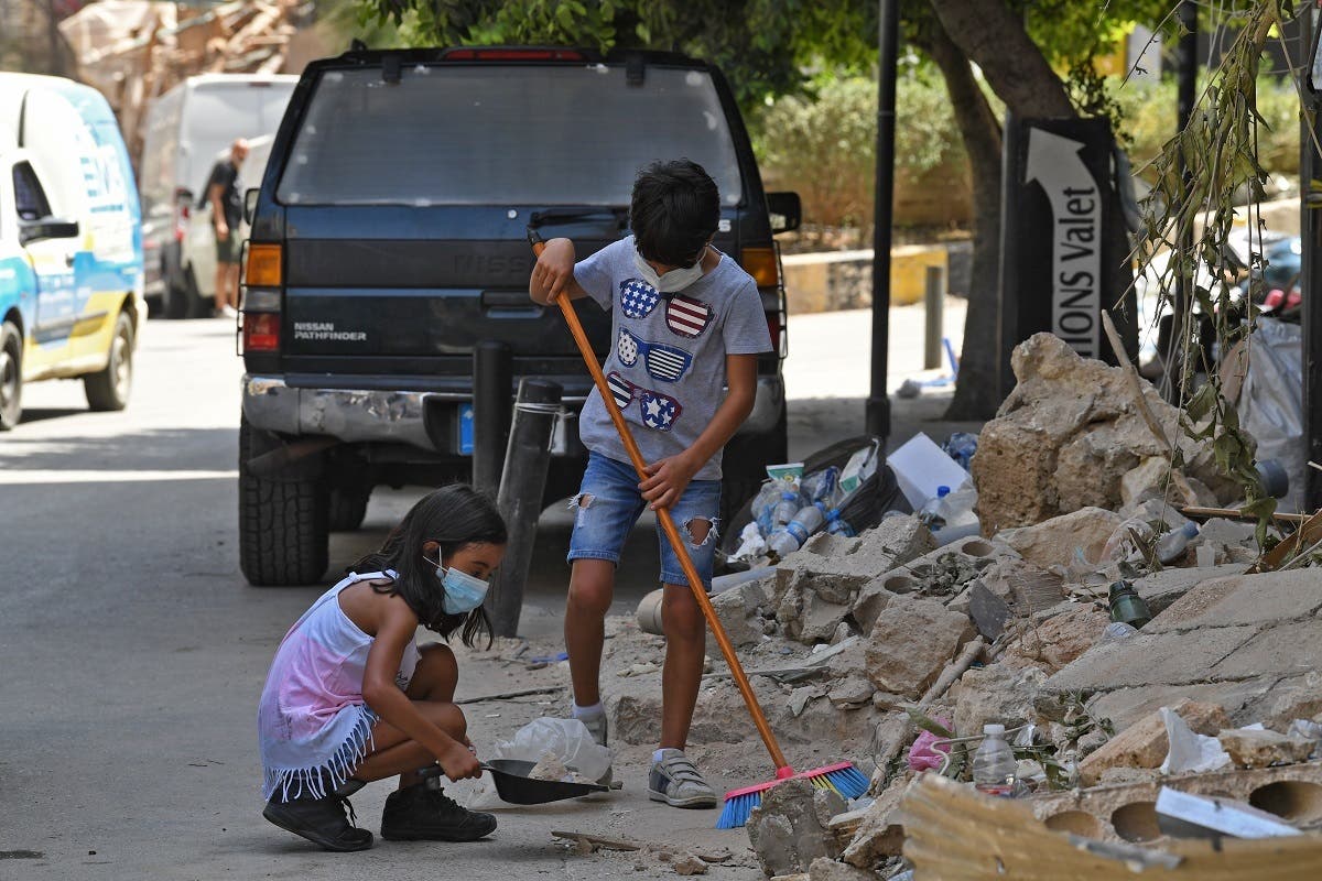 Lebanese children clean debris in Beirut’s Gemmayzeh neighborhood on August 8, 2020, four days after a monster explosion killed more than 150 people and disfigured the Lebanese capital. (AFP)