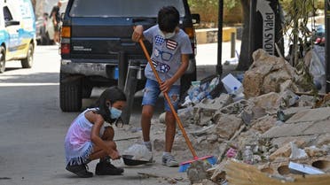 Lebanese children clean debris in Beirut’s Gemmayzeh neighborhood on August 8, 2020, four days after a monster explosion killed more than 150 people and disfigured the Lebanese capital. (AFP)