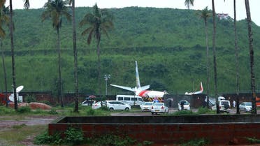 000_1WD4Y2People are seen near the wreckage of an Air India Express jet, which was carrying more than 190 passengers and crew from Dubai, after it crashed by overshooting the runway at the International Airport in Kozhikode, Kerala, on August 8, 2020. (AFP)