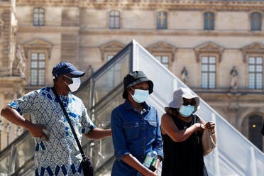 People wearing protective masks walk near the Louvre Museum as France reinforces mask-wearing as part of efforts to curb a resurgence of coronavirus across the country, in Paris, France, on August 6, 2020. (Reuters)