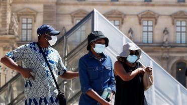 People wearing protective masks walk near the Louvre Museum as France reinforces mask-wearing as part of efforts to curb a resurgence of coronavirus across the country, in Paris, France, on August 6, 2020. (Reuters)