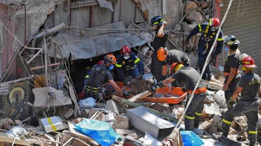 Members of the Lebanese civil defence use a dog to search for victims and survivors under the rubble of a building in the Gemayzeh neighbourhood. (AFP)